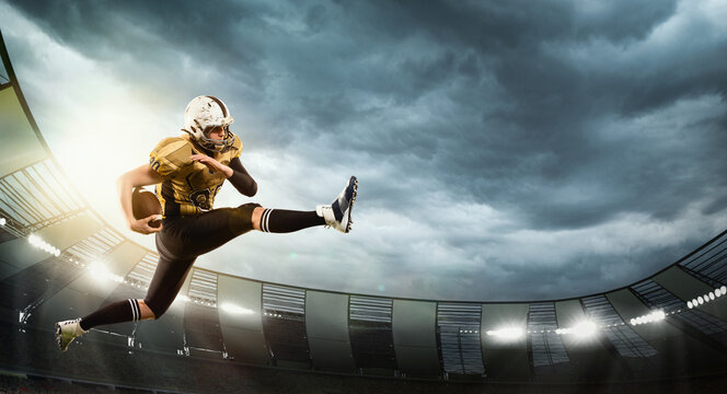 Motivated man, professional american football player in motion, catching ball. Open air 3D stadium in evening with spotlights. Game. Concept of sport, competition, action and motion, game, cup.