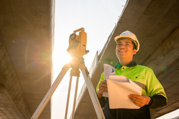 Asian civil engineer specialists examining trades at road construction site, industrial building...