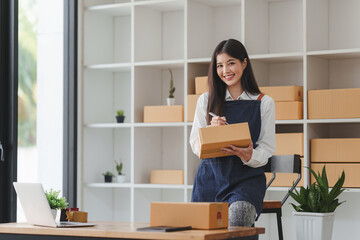 Small businesses SME owners female entrepreneurs check online orders to prepare to pack the boxes, sell to customers, sme business ideas online