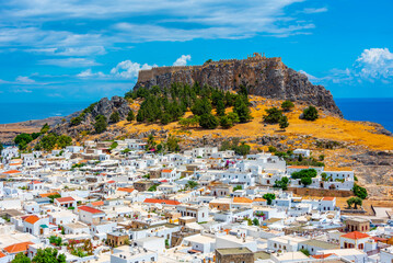 Acropolis of Lindos overlooking traditional white houses at Rhodes island, Greece