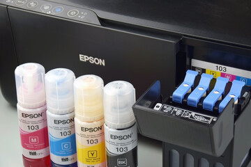 Four bottles of ink Epson, yellow, red, blue, black, built-in to the Epson L3150 series printer.