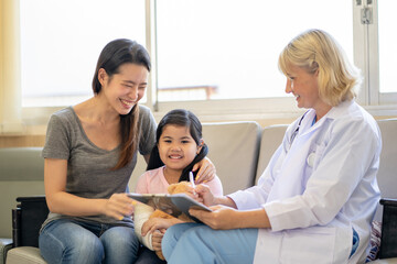 Pediatrician is closely caring and asking about sick girls symptoms, health concepts and child care.