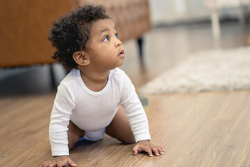 Happy African American Little baby boy crawling and looking for some thing to learn