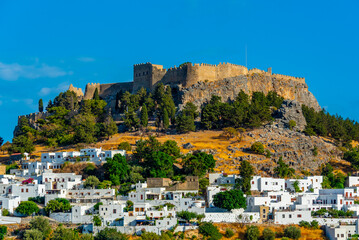 Acropolis of Lindos overlooking traditional white houses at Rhodes island, Greece