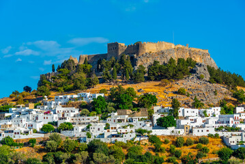 Acropolis of Lindos overlooking traditional white houses at Rhodes island, Greece