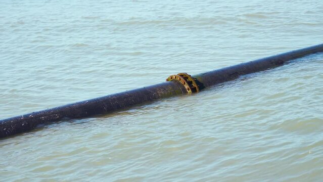 A tube half submerged in sea water