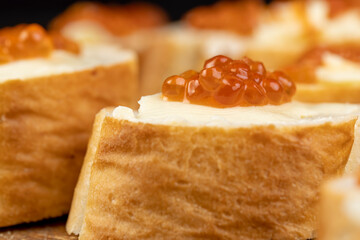 Thinly sliced baguette with salmon caviar and butter