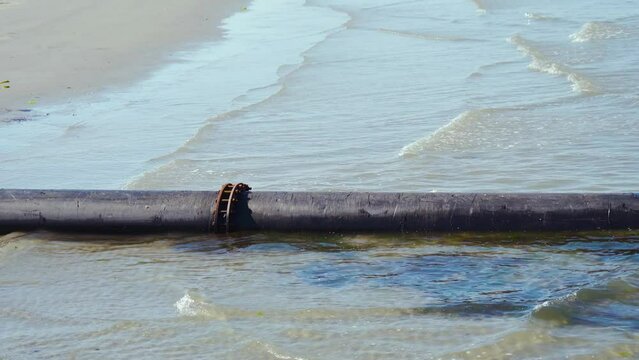 A tube by the sea on the beach and in the water