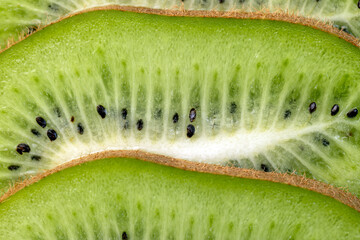 Ripe green kiwi sliced into thin slices