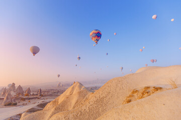 Landscape sunrise in Cappadocia with set colorful hot air balloon fly in sky with sun light. Concept tourist travel Goreme Turkey