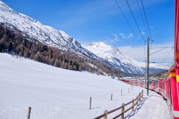 Fototapeta na wymiar The famous Swiss mountain train of Bernina Express crossed italian and swiss Alps