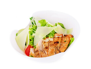 Delicious fresh Caesar salad in bowl on white