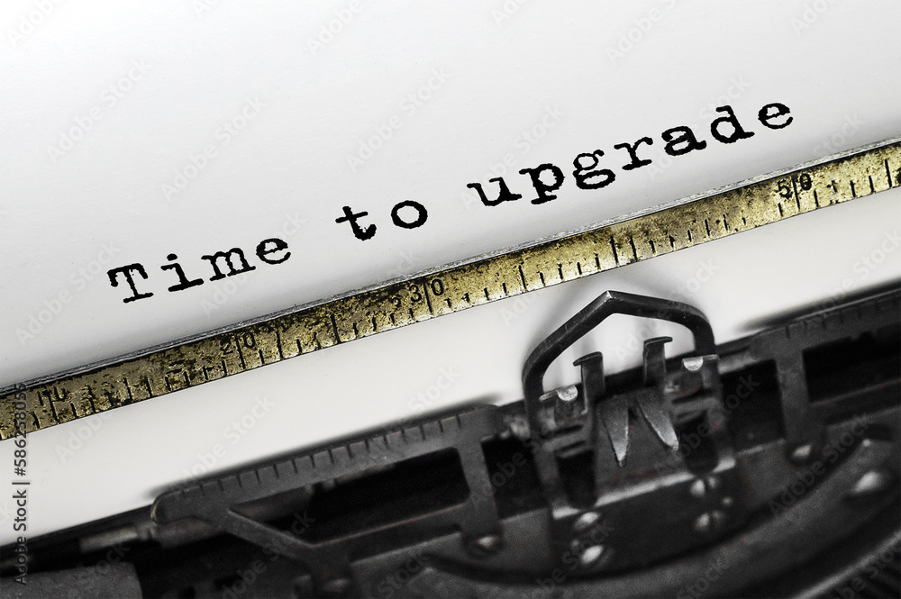 Poster text time to upgrade typed on retro typewriter