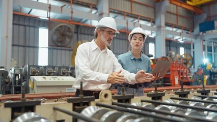 Workers partners holding tablet walking at manufacturing factory manager leader industrial specialist discussing project work with woman engineer warehouse. Teamwork concept