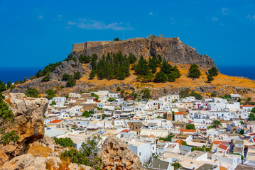 Acropolis of Lindos overlooking traditional white houses at Rhodes island, Greece
