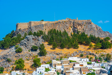 Acropolis of Lindos overlooking traditional white houses at Rhodes island, Greece