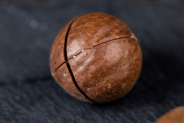 Unpeeled macadamia nuts on the table