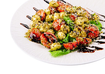 salad with tomatoes and mozzarella cheese with basil leaves and strips of soy sauce