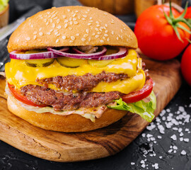 Fresh tasty burger on wooden board
