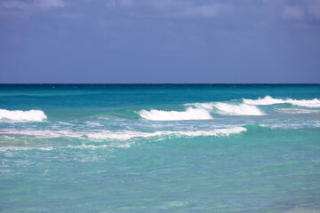 View to azure sea waves and blue sky. Caribbean coast, background for holidays on a nature