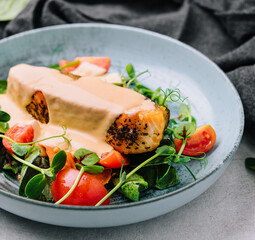 Grilled salmon fillet with spinach and creamy sauce