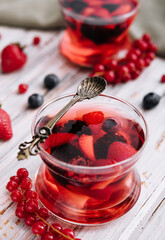 Jelly with fresh berries on wooden table close up