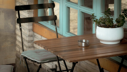 Vintage decorated  mediterranean cafeteria front view with potted flower on the table.  Classic vintage coffee shop