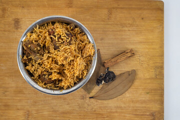 Mutton-Meat Biryani or mutton Dum Biryani is a Indian special food for all festival and occasions, Eid, Diswali and Christmas. South Indian spicy mutton biryani with onions on isolated background..