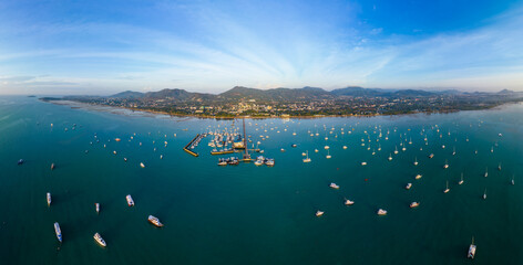 Aerial panorama view of Chalong pier with many boats at sunrise, Phuket, Thailand