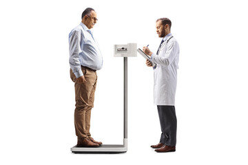 Mature man weighing on a professional scale and doctor writing a document