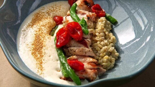 Rabbit Fillet on Dinner Plate Served Green String Beans, Tomatoes and Bulgur Garnished. Art Food Gourmet Meal. Roasted White Meat with Sauce. Trendy Authentic Porcelain, Restaurant Tasty Dish Close-up