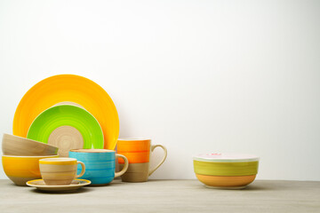 Set of colored ceramic dishware front view
