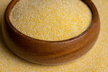 Round wooden bowl with dry corn flour