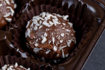 Chocolate candies in the form of balls with milk coconut