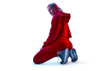 Young white fitness woman in red sportswear sitting, turned back looking down. Blue red color neon light.