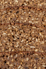 Black rye bread cut into chunks with sunflower seeds