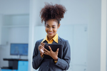 Fototapeta na wymiar African American businesswoman holding digital tablet in hands.
