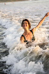 woman in the sea smiling having fun splash heart happy playful joyful 