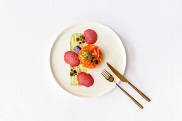 Salmon tartare with strawberries on a white plate