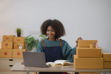 Young African American woman and online selling at home office, Startup small business owner working Online selling and product order for delivery to customer.