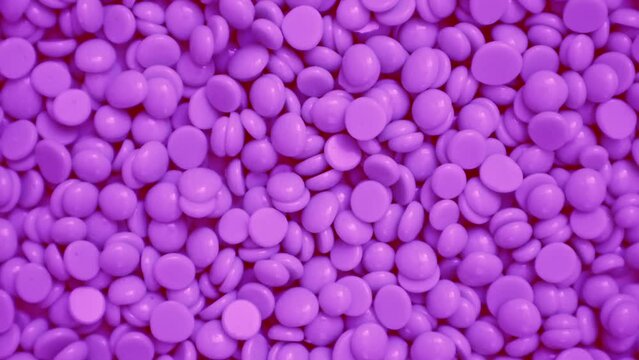 Wax granules for depilation. Background wax texture. Epilation, depilation, removal of unwanted hair. Rotation. View from above. High quality 4k footage