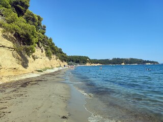 Turquoise waters - summer vacation in exotic islands. Wild and beautiful seaside beach with pine trees. Mediterranean sea - wild, exotic islands