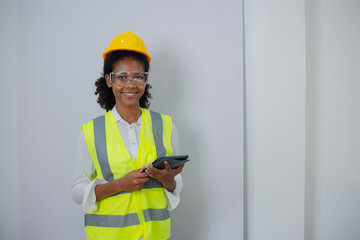Engineering African American businesswoman holding digital tablet and computer in hands. African American woman builder using touchpad,  Constuction,