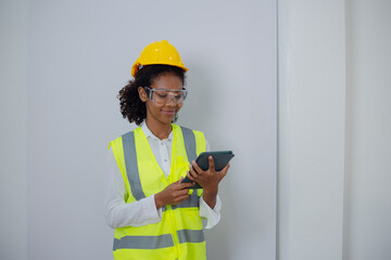 Engineering African American businesswoman holding digital tablet and computer in hands. African American woman builder using touchpad,  Constuction,