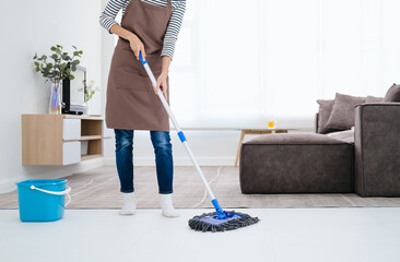 Young Woman Mopping Floor At Home