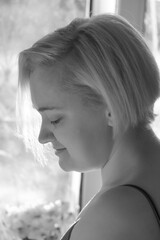 Girl in a bra in an apartment opposite the window
