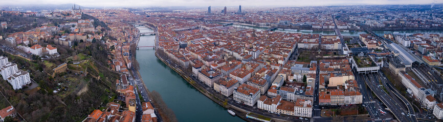 Fototapeta na wymiar Aerial around the old town of the city Lyon in France on a cloudy afternoon in late winter