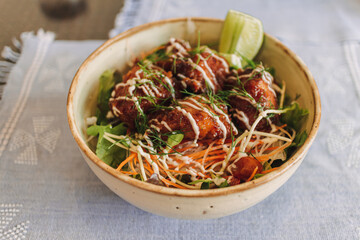 Japanese teriyaki rice with topping sauce served in a bowl.