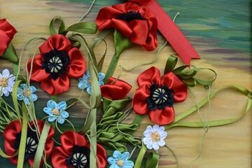 A background of flowers made of ribbons, ropes and threads. A bouquet of poppies. Wildflowers
