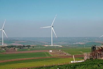 Wind turbine and windmill. Clean energy in green nature in different locations. Sustainability and environment concept  © Bigy